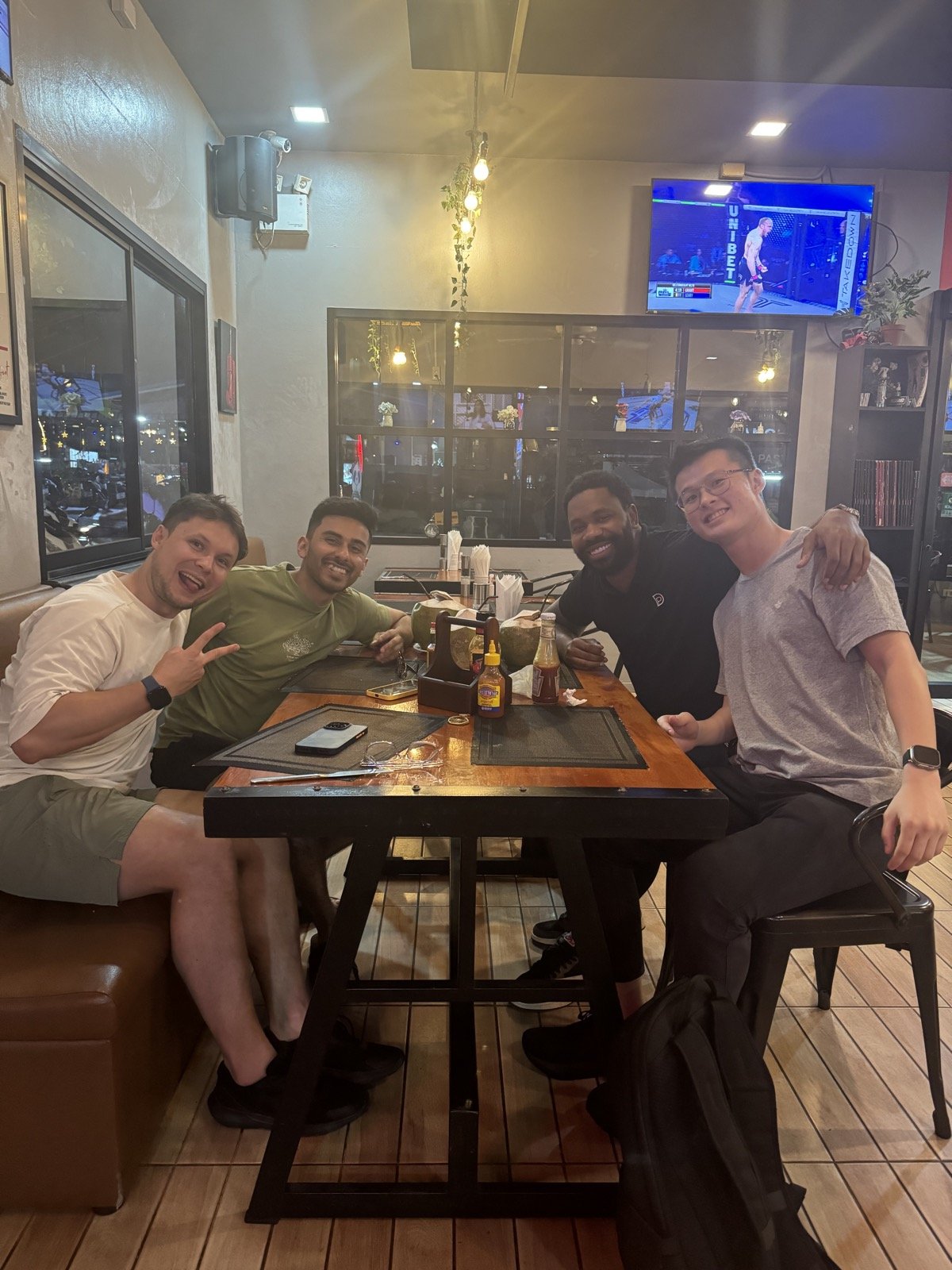 Four people sitting together at a restaurant table